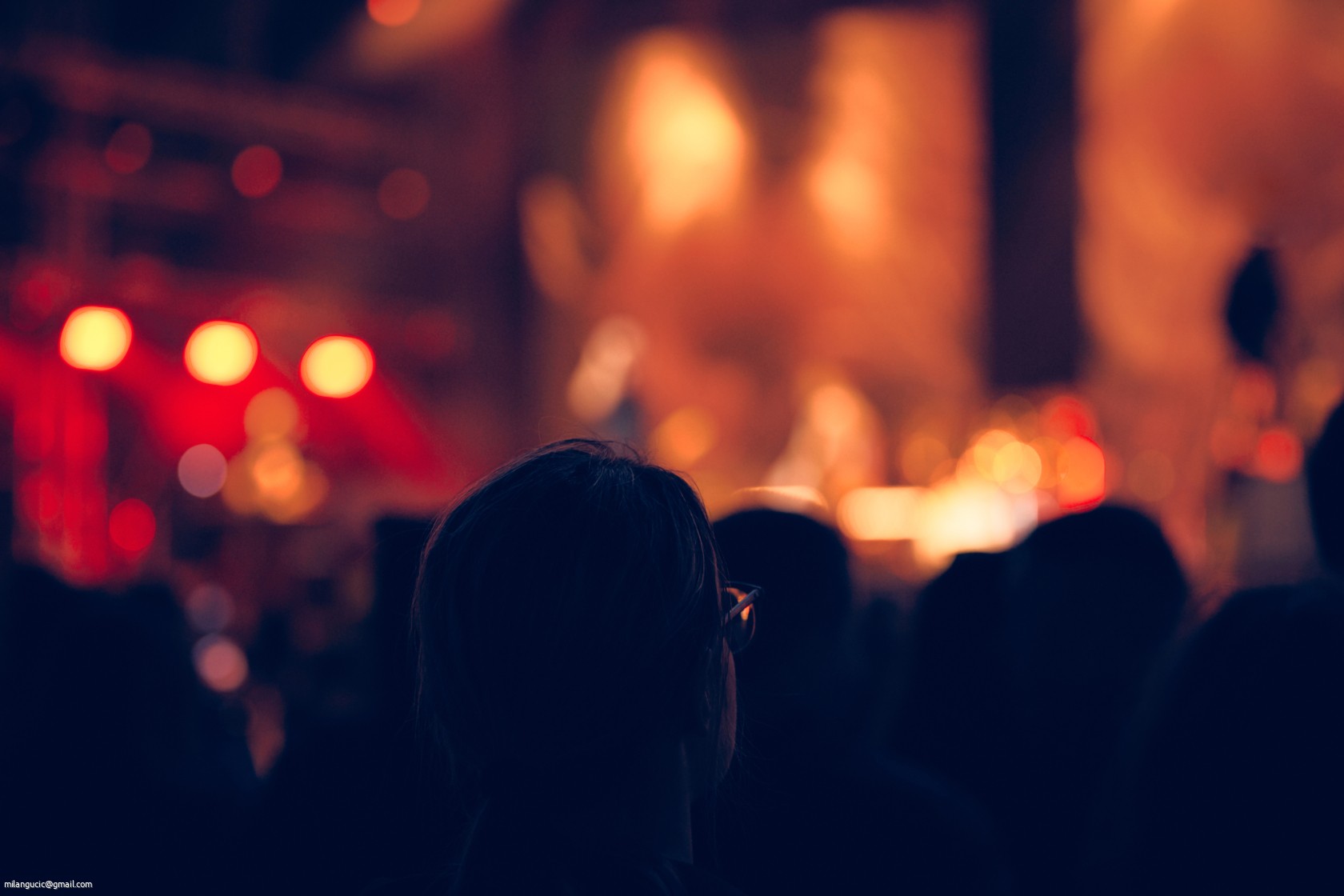 De-focused concert stage with laser lights and beams.
