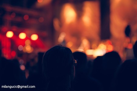 De-focused concert stage with laser lights and beams.